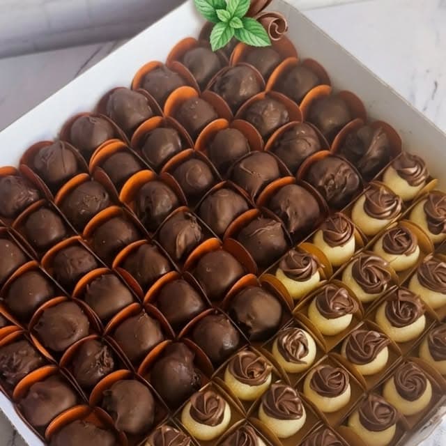 Caixa de docinhos de chocolate em forminhas, lado a lado